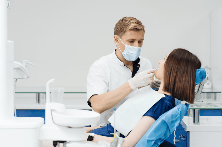 a lady is having dental treatment from a young dentist