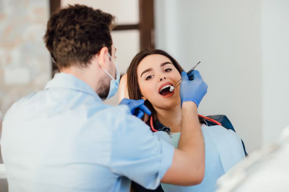 a dentist is checking a lady