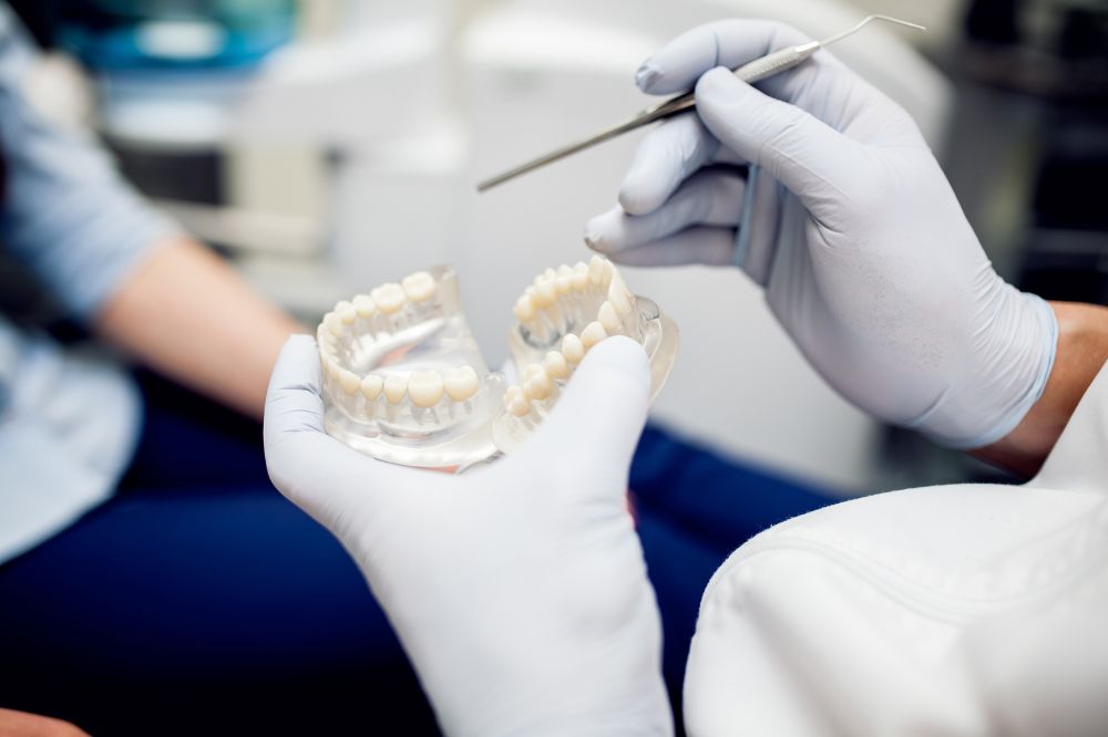 a dentist is showing dental crown demo