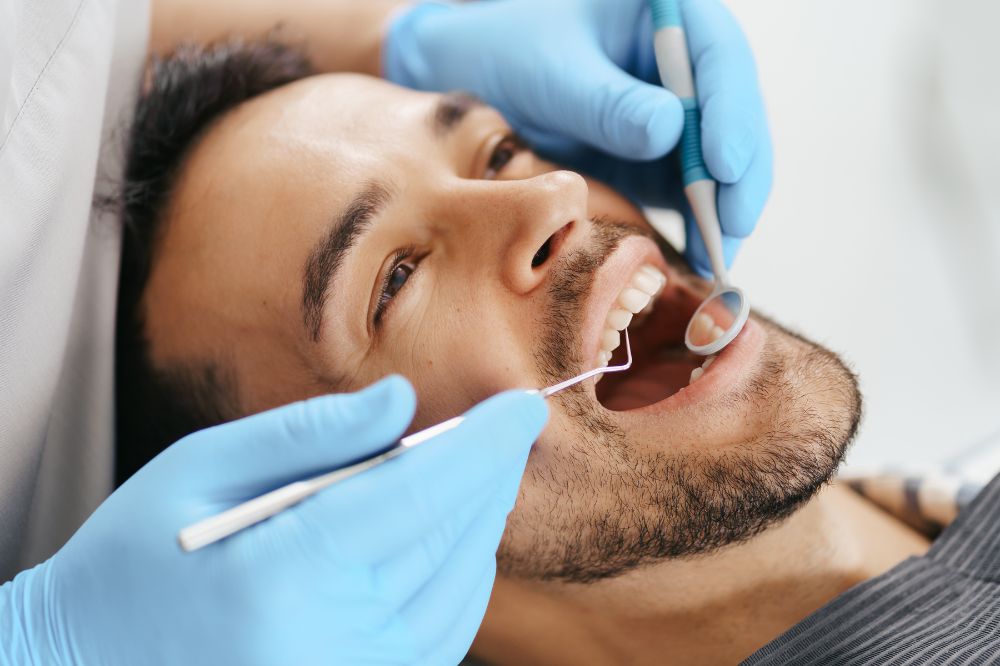 A man is getting tooth extractions treatment